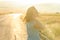 Backlit portrait of woman on the road