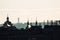 Backlit Prague skyline buildings siwh smoke chimneys silhouette