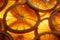 Backlit ripe orange rings form a textured, visually striking background