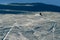 Backlit silhouette of man in action practicing ski going fast and aggressive down snow slope winter sport