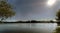 Backlit view of a lake formed by a marsh called Cecebre in Galicia (Spain), with sun in sight