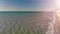 Backlit view of ocean at sunset from drone