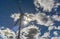 Backlit wind turbine on a cloudy day