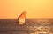 Backlit windsurfer at sunset