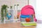 Backpack,apple, school supplies on the background of the school classroom .Back to school and kindergarten . The beginning of the