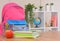 Backpack,apple, school supplies on the background of the school classroom .Back to school and kindergarten . The beginning of the
