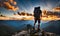 Backpack-clad traveler standing atop a mountain, overlooking a panoramic vista in the late afternoon