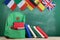 backpack, flags of Spain, France, Great Britain and other countries, books and school supplies of the blackboard