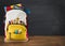 Backpack full of school supplies over black school board background