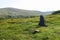 Backpack on the grass meadow with mountains on the background. Summer hiking motivational image. Space for text