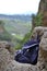 Backpack on rock in Ronda, Andalusian town in Spain at the Puente Nuevo Bridge over the Tajo Gorge, pueblo blanco