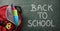 Backpack school detail on green blackboard back to school message