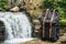 Backpack tourism on the background of the river and the waterfall. Traveler holiday concept, travel adventure. Copy, empty space