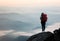 Backpack woman standing on the hill with beautiful nature