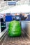 backpack wrapped in green plastic weighed at check-in counter before departure