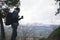 Backpacked male traveler drinking coffee while hiking in mountains. People. Travel. Active tourism and trekking concept