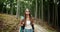 Backpacked Woman Walking in Forest