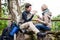 Backpacker couple taking rest aside hiking trail