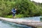 Backpacker crossing the river.