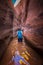 Backpacker Girl in the water Zebra Slot Canyon Escalante Utah