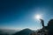 Backpacker hiker on the mountain hill in contrast sunlight going