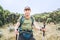 Backpacker man portrait having a hiking walk with trekking poles on the Umbwe route in the forest to Kilimanjaro mountain. Active