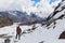 Backpacker mountaineer standing snow mountain pass above glacier