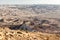 Backpacker mountaineer tourist ascending stone desert mountain slope