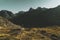 Backpacker in the mountains of Lofoten observing the panoramic views