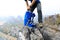 Backpacker packing the backpack on mountain top cliff edge