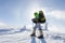 Backpacker is posing in winter mountains