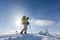 Backpacker is posing in winter mountains