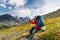 Backpacker rests in green highlands of Altai mountains