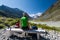 Backpacker rests in green highlands of Altai mountains, Russia