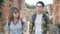 Backpacker sweet couple enjoy their journey at amazing landmark in traditional city.