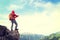 Backpacker taking photo on mountain peak