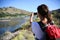 Backpacker taking photos of Limay river, Patagonia