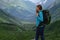 Backpacker on top of a mountain enjoying valley view