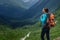 Backpacker on top of a mountain enjoying valley view