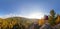 Backpacker on top of a rock fall at dawn panorama