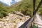 Backpacker tourist crossing suspension bridge forest jungle, Bolivia