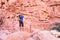 Backpacker tourist man standing desert stone canyon mountain trail