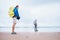 Backpacker travelers father and son stay on ocean desret beach
