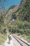 Backpacker walking on the railroad track to Machu Picchu, Peru, alternative to the usual tourist train connection. Machu Picchu ar