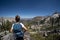 Backpacker woman hiker stands on the edge of a rock in Sawtooth National Forest