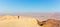 Backpacker woman tourist walking desert stone mountain plateau.