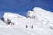 Backpackers climbing a mountain in winter