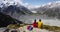 Backpackers couple hiking looking at Mount Cook view