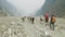 Backpackers with guide walk on the Manaslu mountain circuit trek in Nepal.