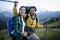 Backpackers happy young couple hiking with sticks